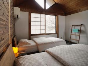 Postel nebo postele na pokoji v ubytování Shiraishi Island International Villa