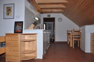 a kitchen and dining room with a table and chairs at Sklípek u kapličky in Velké Bílovice