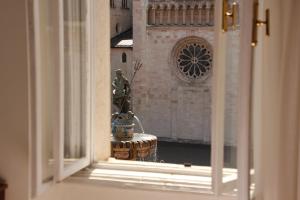 a view of a fountain through a window at Hotel Venezia in Trento