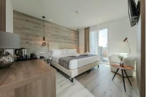 a bedroom with a white bed and a wooden wall at Hotel Oasis in Barcelona