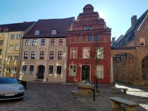 a group of buildings with a car parked in front at Rooftop Chalet in Stralsund