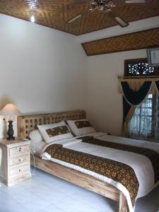 Postel nebo postele na pokoji v ubytování Arsa Homestay & Spa