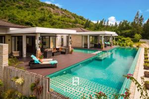 a swimming pool in front of a house at 5 Bedroom Amazing Pool Villa In Resort TS1 in Hua Hin