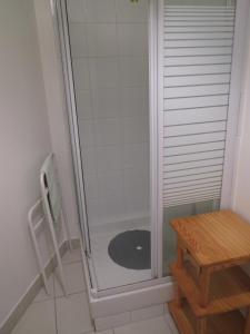 a bathroom with a shower with a toilet and a table at T1 centre ville Aubenas in Aubenas +22 photos
