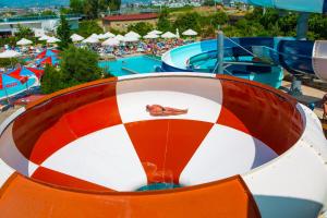 a person laying on top of a ride at a water park at Kahya Resort Aqua & Spa in Konaklı