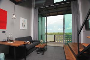 a living room with a couch and a table at Space59 Hotel in Ratchaburi