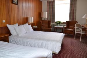 Tempat tidur dalam kamar di Fletcher Hotel De Zalm