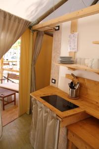 a kitchen in a tent with a counter top at Campeggio Europa in Torre del Lago Puccini