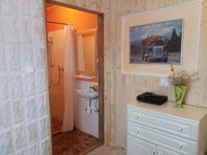 a bathroom with a sink and a mirror at Diofa apartman in Abda