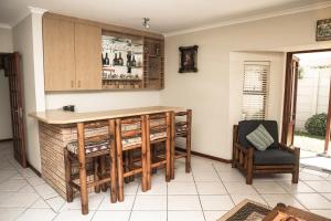a kitchen with a counter and a chair in a room at Rothesay House in Bloubergstrand