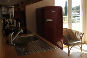 a kitchen with a sink and a refrigerator at Premantura,Natura,Rt Kamenjak in Premantura