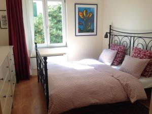 a bedroom with a bed with a black frame and a window at Premantura,Natura,Rt Kamenjak in Premantura