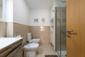 a bathroom with a toilet and a glass shower at RK Atlantis Vacational in Las Palmas de Gran Canaria
