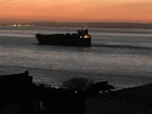a barge on the water at sunset at The Nook @ Drop Anchor in Portishead