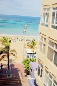 a view of the beach from the balcony of a building at RK Atlantis Vacational in Las Palmas de Gran Canaria
