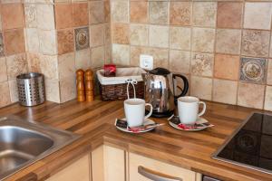 a kitchen counter with two coffee cups and a sink at Couples Getaway in Bohinj