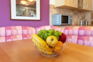 a bowl of fruit on a wooden table at Couples Getaway in Bohinj