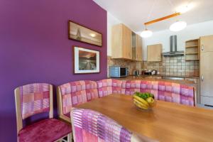 a dining room with a table with a bowl of fruit on it at Couples Getaway in Bohinj