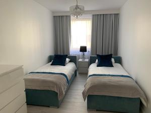 Posteľ alebo postele v izbe v ubytovaní Apartament Zacisze De LUX