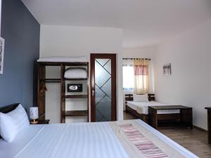 a bedroom with a bed and a bunk bed at HOTEL H1 MANAKARA in Manakara