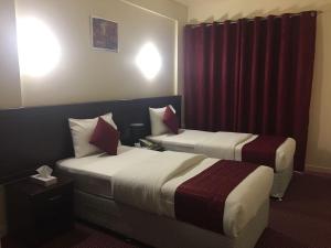 Postelja oz. postelje v sobi nastanitve Simba Hotel