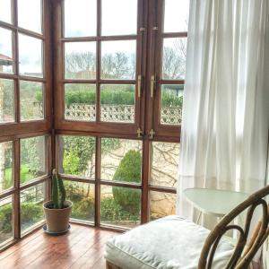a room with a large window with a table at Centrico Y Acogedor in Comillas