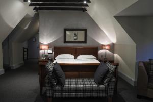 a bedroom with a bed with two lamps on it at Hotel Du Vin Edinburgh in Edinburgh