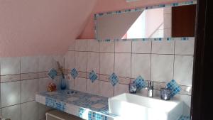 a bathroom with a sink and a mirror at Valloris Apartments in Hévíz