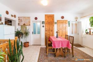 a kitchen and dining room with a table and chairs at PENSIUNEA BORDÁS PANZIÓ in Sfântu-Gheorghe