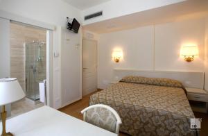 A bed or beds in a room at Locanda Dei Cinque Cerri