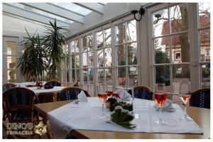 a dining room with two tables with wine glasses at Dino's Trinacria in Friesenheim