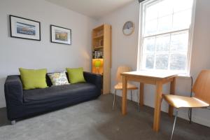 a living room with a couch and a table at The Bolthole - Fantastic Old Town Location! in Edinburgh