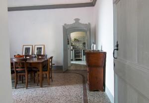 a dining room with a table and a mirror at Villa Corinna in Ventimiglia