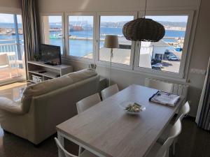a living room with a dining room table with a view of the ocean at Apartaments la Catifa now with ELEVATOR!!! in Palamós