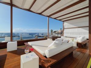 a bedroom with a bed and a large window at H10 Gran Tinerfe - Adults Only in Adeje