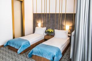 Posteľ alebo postele v izbe v ubytovaní Platinum Residence Boutique