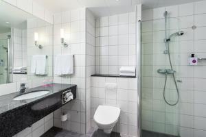 a bathroom with a shower and a toilet and a sink at Quality Hotel Fredrikstad in Fredrikstad