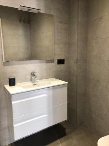 a bathroom with a white sink and a mirror at Apartamentos Kronox in Nerja +17 photos