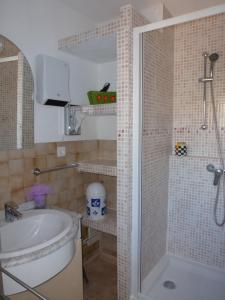een badkamer met een douche, een wastafel en een bad bij La Pergola de la Plage in Gruissan +30 foto's