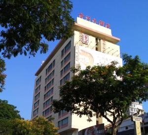 a tall white building with a sign on it at Red Rock Hotel Penang in George Town