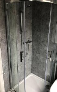 a shower with a glass door in a bathroom at City Centre Townhouse-3 Bedrooms & Parking - Excellent Location in Belfast +8 photos