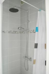 a shower with a shower head and a shower curtain at Coup de coeur assuré pour cette charmante maison à 400 m de la plage in Saint-Gilles-Croix-de-Vie
