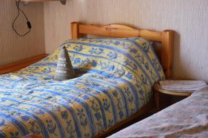 a bed with a blanket and a book on it at Belle maison à 600 mètres de la grande plage de Saint-Gilles-Croix-de-Vie in Saint-Gilles-Croix-de-Vie