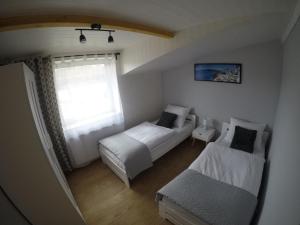 Postel nebo postele na pokoji v ubytování Apartamenty pod Dzikowcem