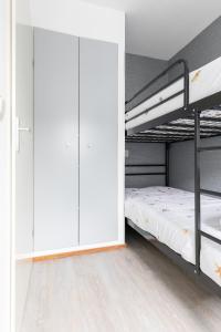 a bedroom with two bunk beds and a closet at Amelander Kaap 126 in Hollum +21 photos