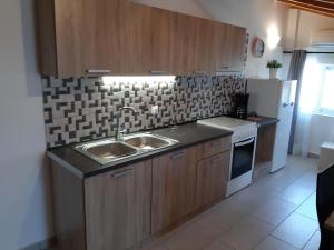 a kitchen with a sink and a stove at Skala Pearls Sofita in Skala