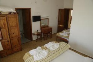 a room with two beds with towels on the floor at Murat Hotel in Demre