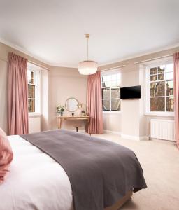 a bedroom with a large bed and a large window at Cathedral House in Glasgow