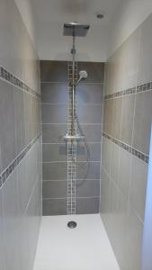 a shower with a shower head in a bathroom at Un style balnéaire moderne pour profiter de la mer in Pornichet