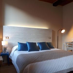 a bedroom with a large bed with blue pillows at Bellambra in Monterosso al Mare